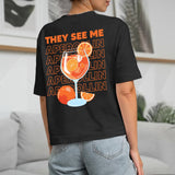 schwarzes Frauen T-Shirt Rückenprint mit "They see me aperolin" personalisiertesm Spruch als Sommer Geschenkidee von Love & Faith